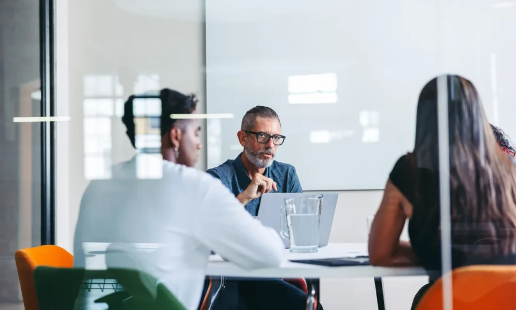 An image of a business consultation meeting where the discussion focuses on AI powered websites