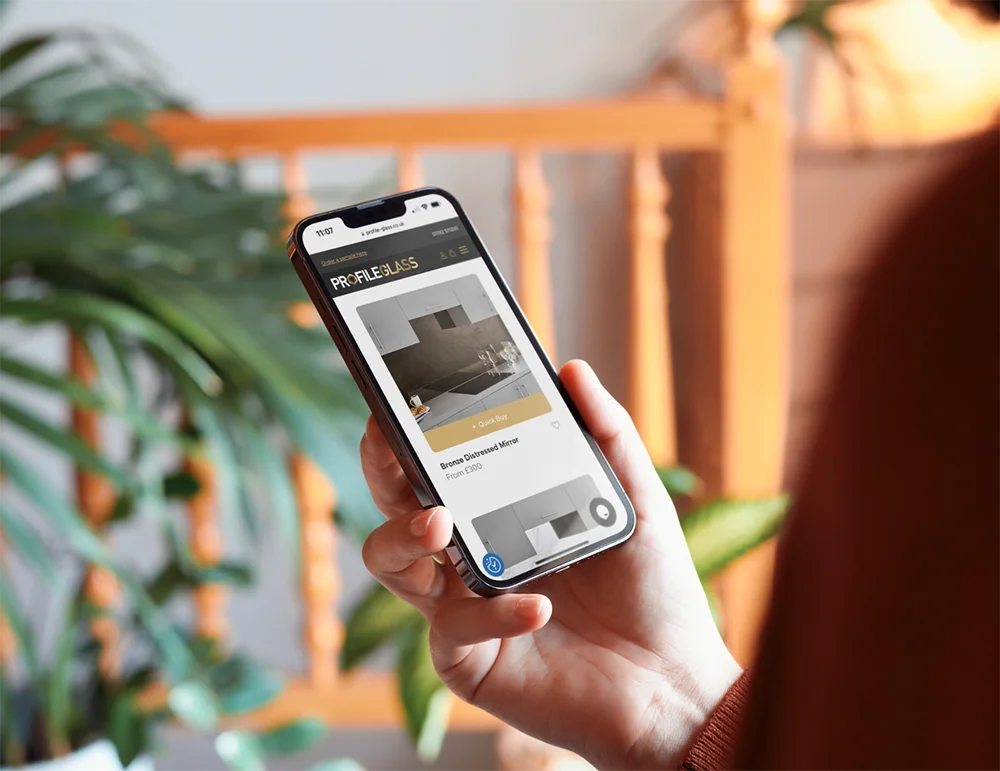 An image of a user browsing through the new website design created by Yellow Circle Web Solutions Limted for a bespoke glass manufacturer, based in Stoke on Trent, Staffordshire. The website is mobile friendly, as can be seen in the image of the obile site running on an iPhone.