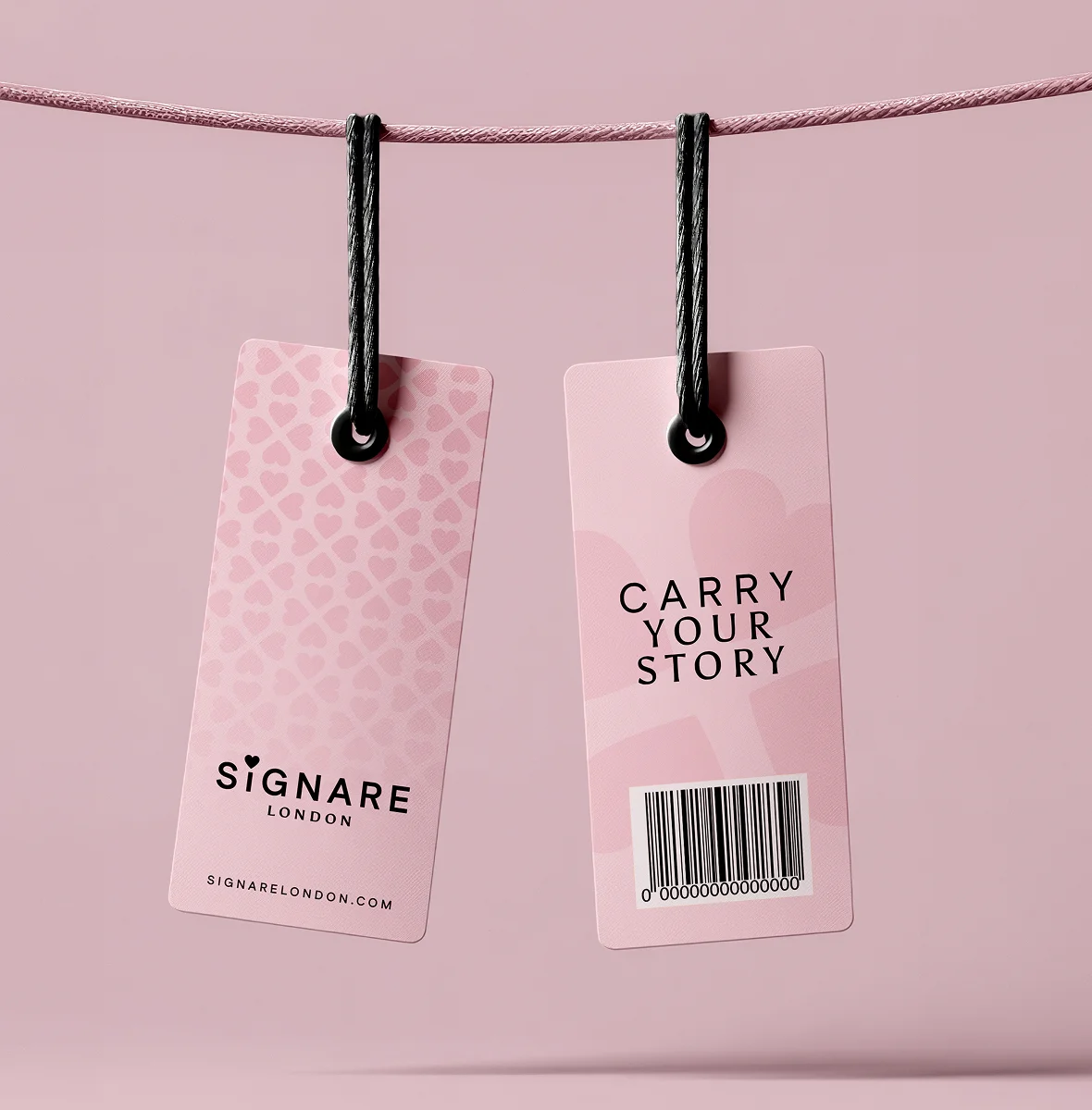 Signare London product tags hanging from a string on a pink background