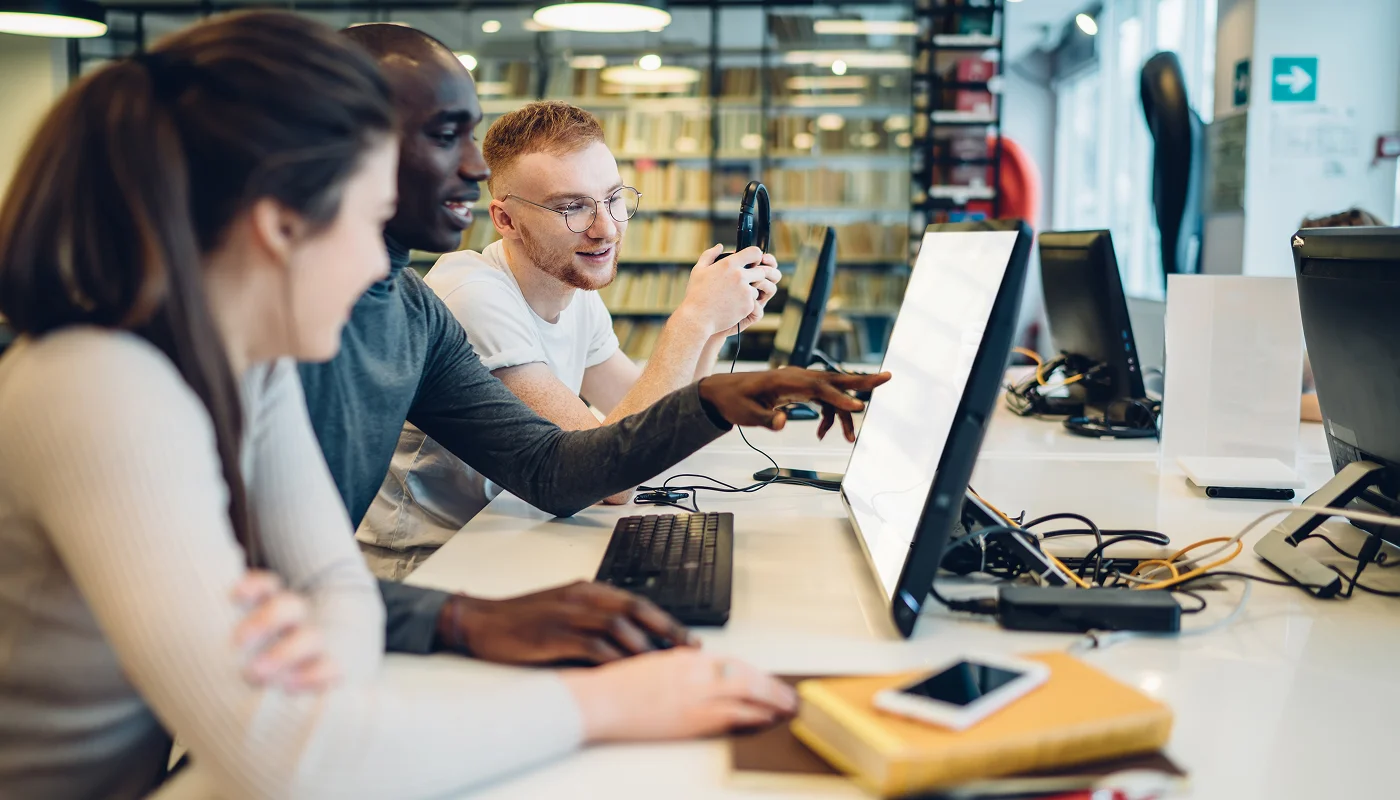 team of people reviewing a website on a desktop computer