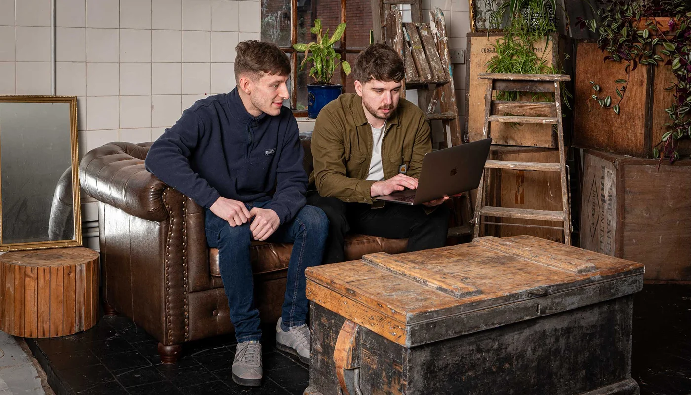 web designer and developer working together to review a brief