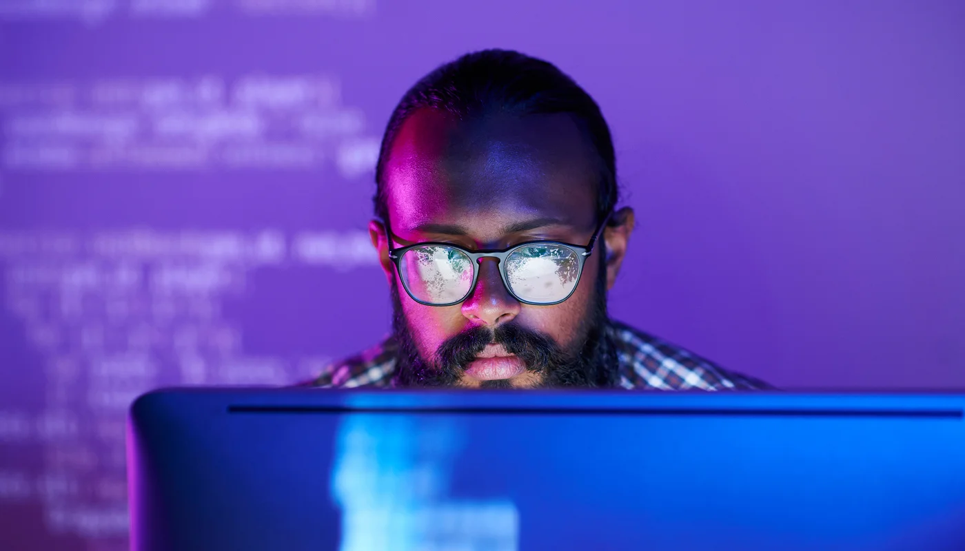 website developer writing code with purple background