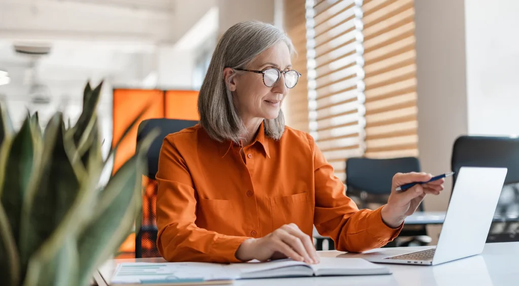 older professional using a laptop to research why unique content is so important in seo