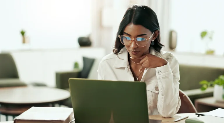 Professional using laptop to review website maintenance service plans