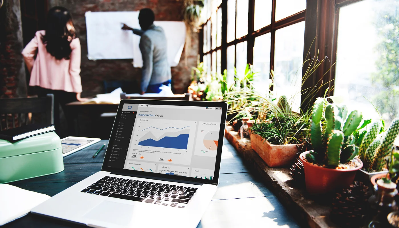 Laptop in cool office showing statistics and analytics
