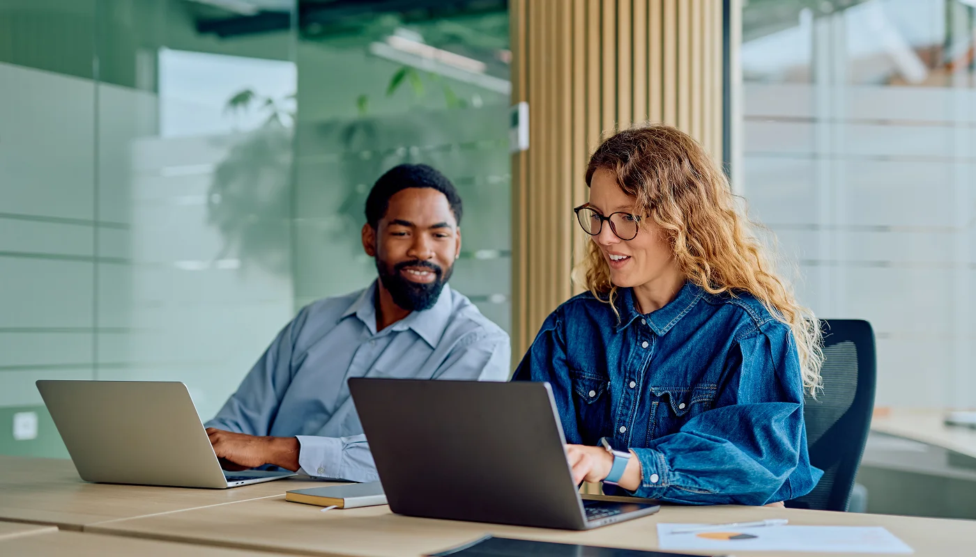 team of two in modern office space working on laptops