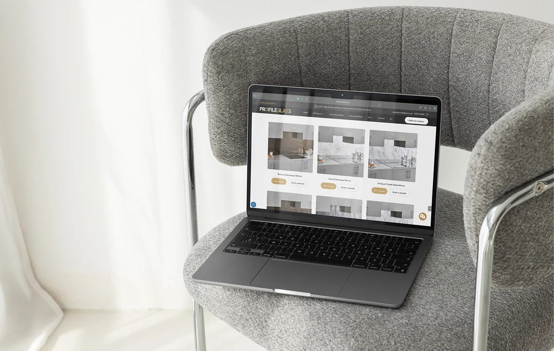 modern ecommerce website displayed on a laptop on a grey chair