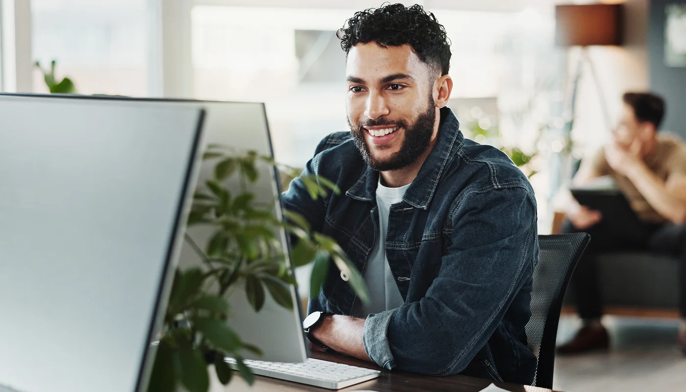 happy business owner using computer to research what is ux design