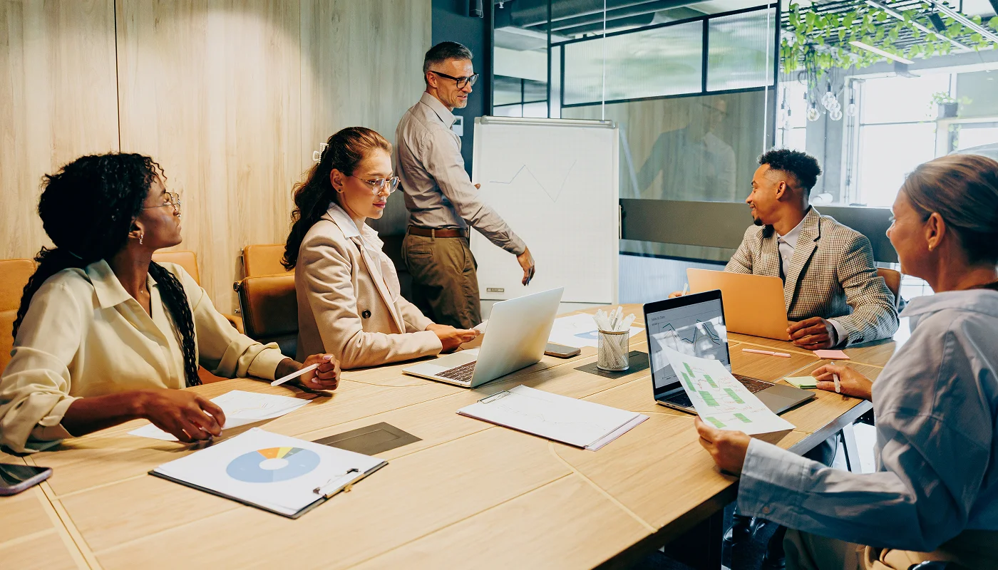 marketing team in a boardroom using whiteboard to plan website content strategy