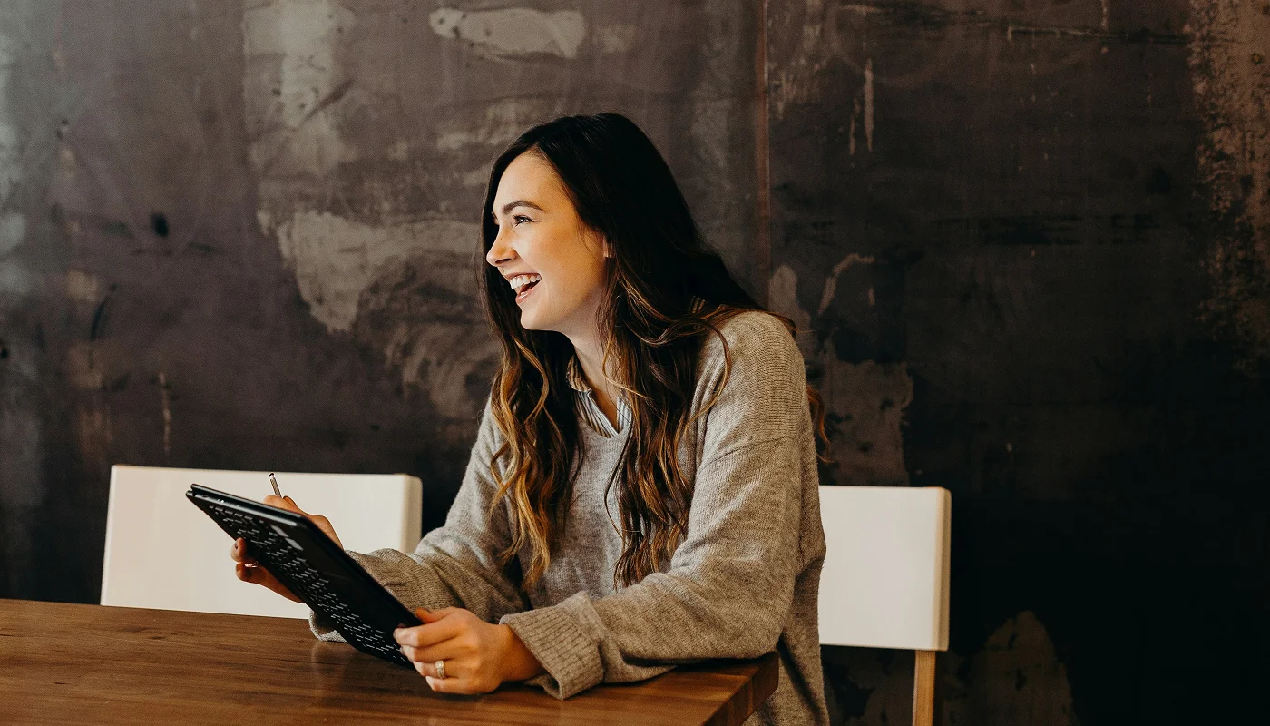 smiling business woman holding an iPad
